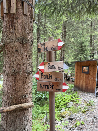 Wooden forest signpost pointing to a fly-line, Roma, Berlin and Nature